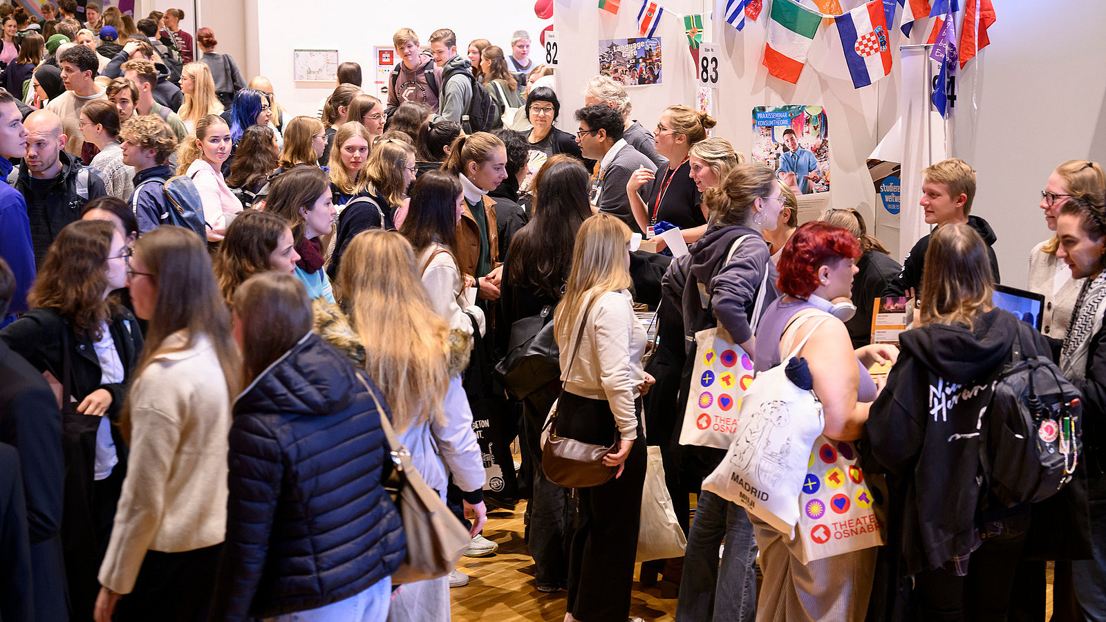 View of colorful booths with numerous people gathering information