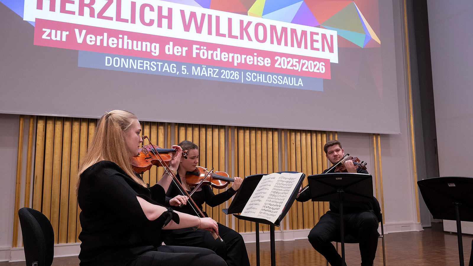 A string quartet plays on stage