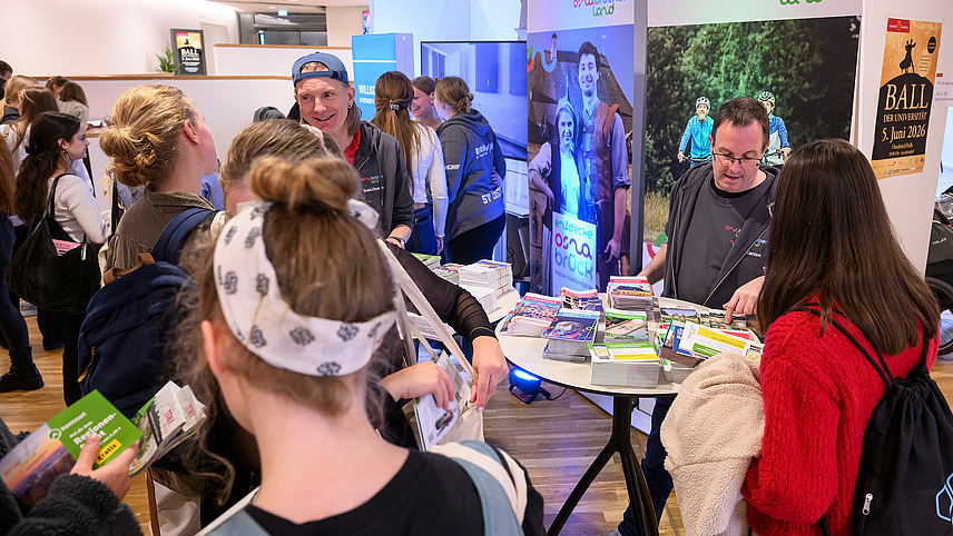 View of colorful booths with numerous people gathering information