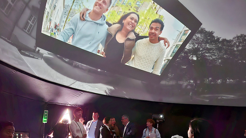 Immersive installation with portraits and cityscapes.