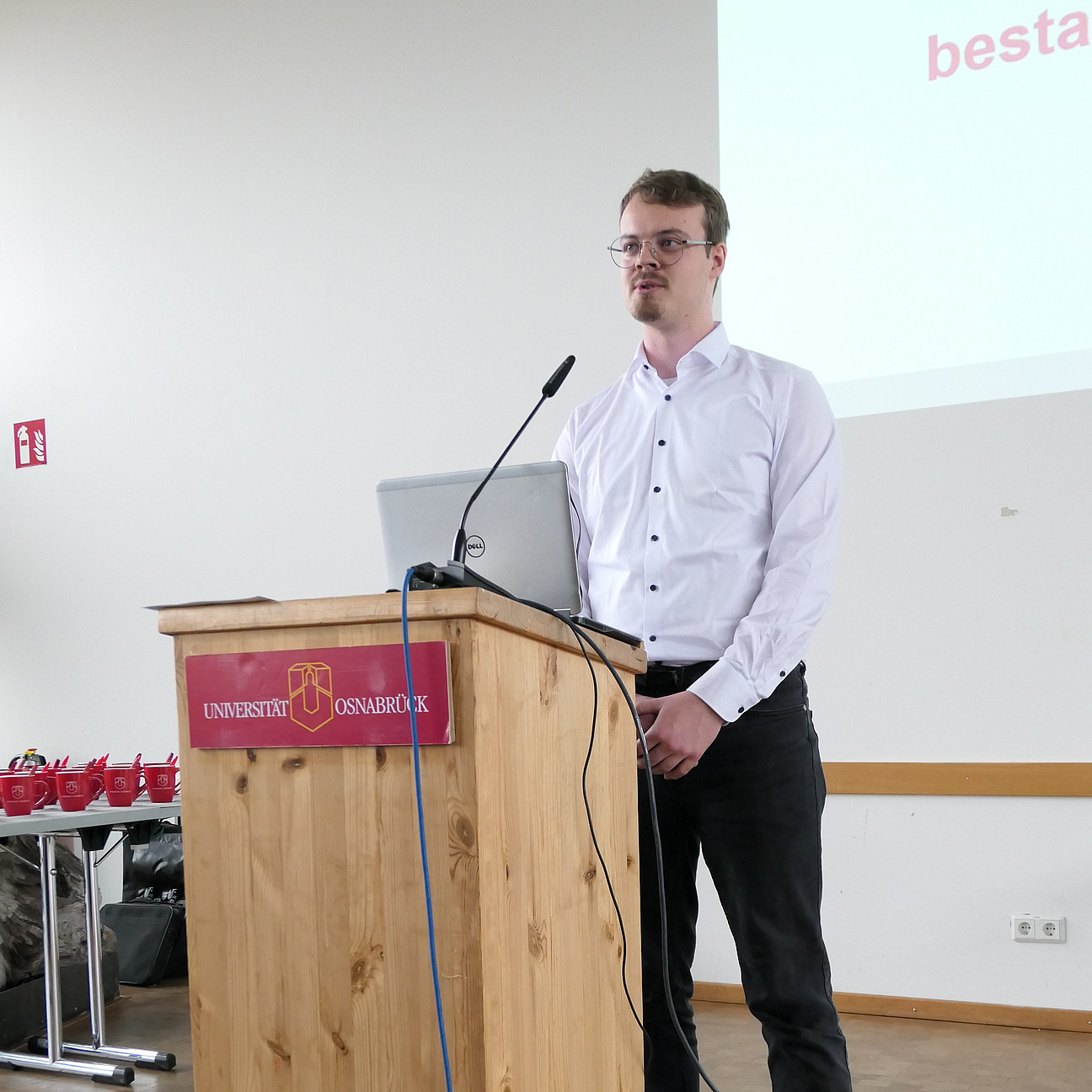 A student stands behind a lectern.