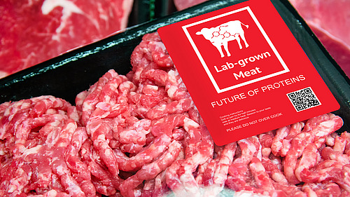 Packaged meat with a sticker that says ‘lab-grown meat’.