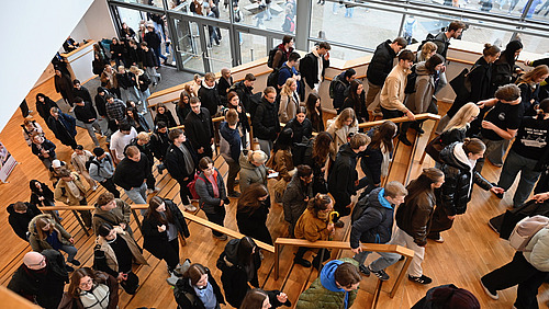 Students walk up a flight of stairs. 