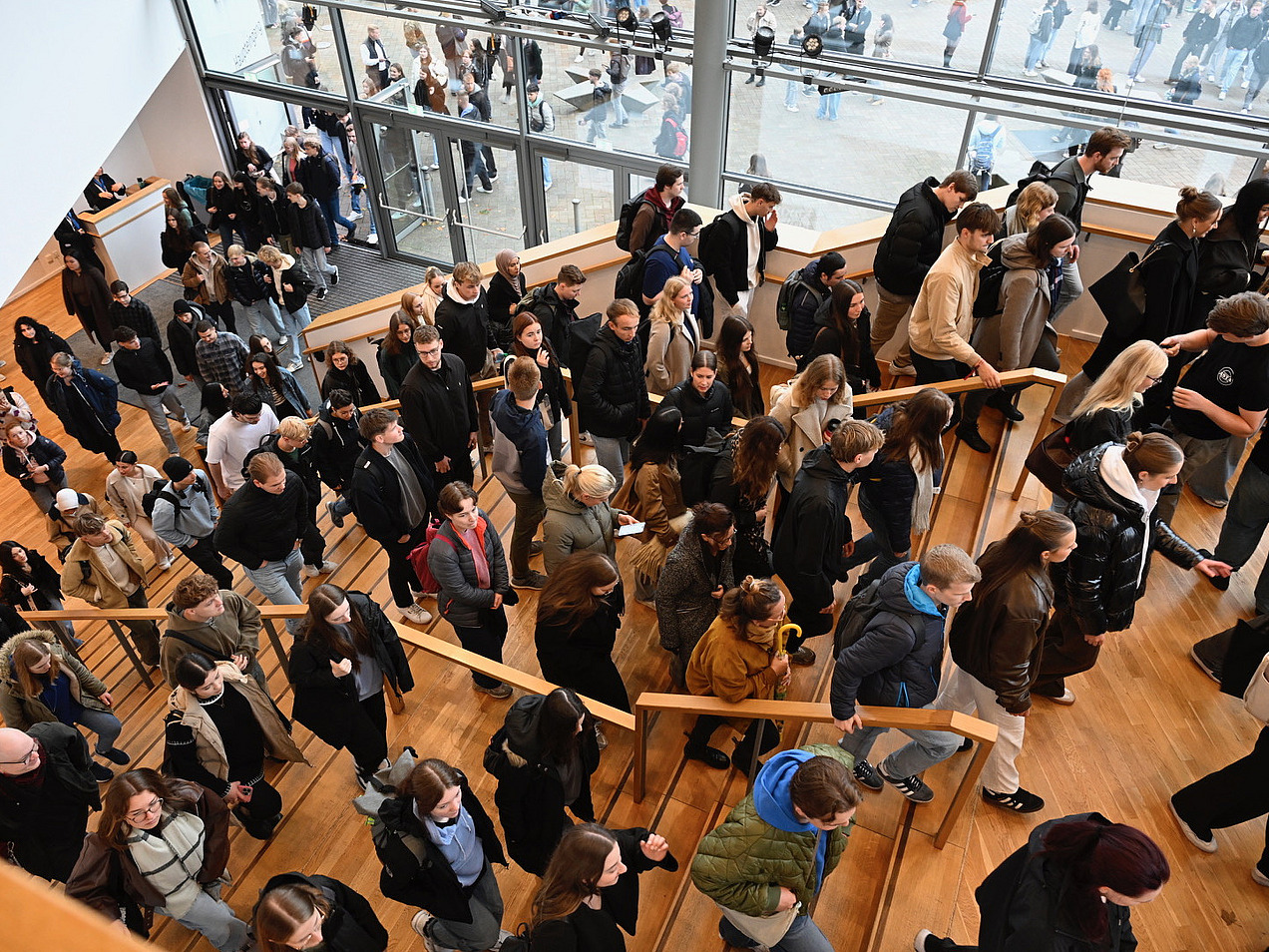 Students walk up a flight of stairs. 