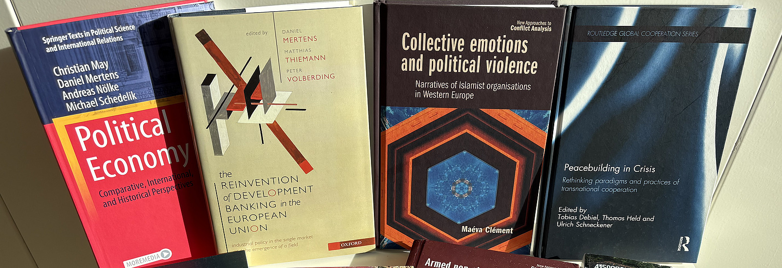Books by authors from the Center for the Study of Conflict and Peace spread out on a table