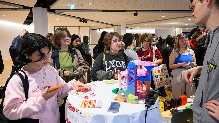 View of colorful booths with numerous people gathering information