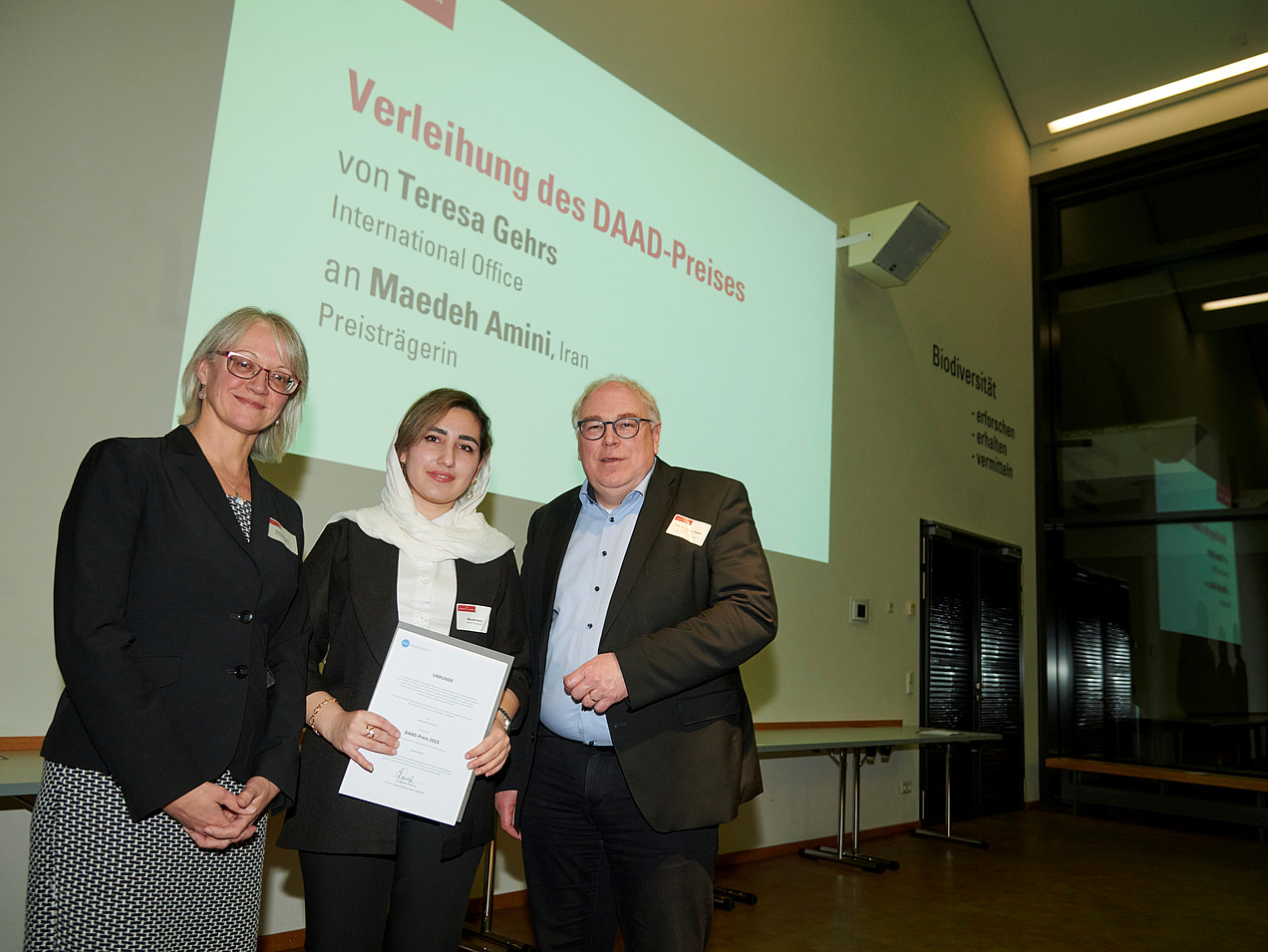 Two women and a man in front of the camera.