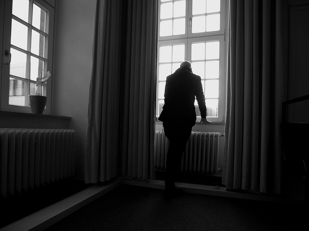 A man looks out of the window.