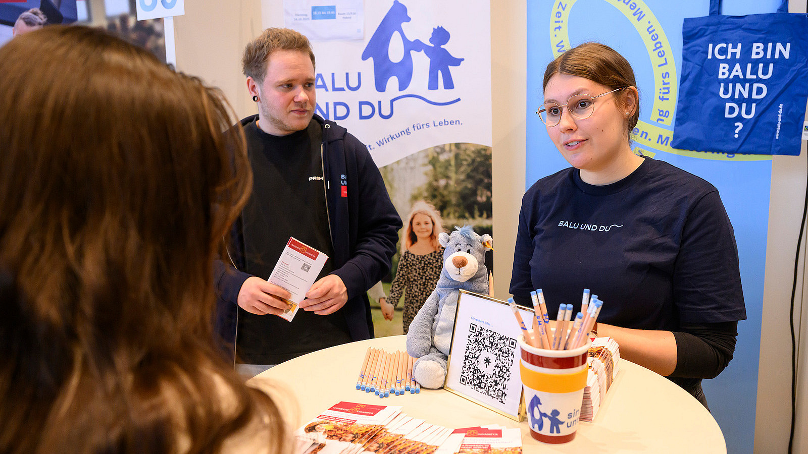 Several people at an information booth