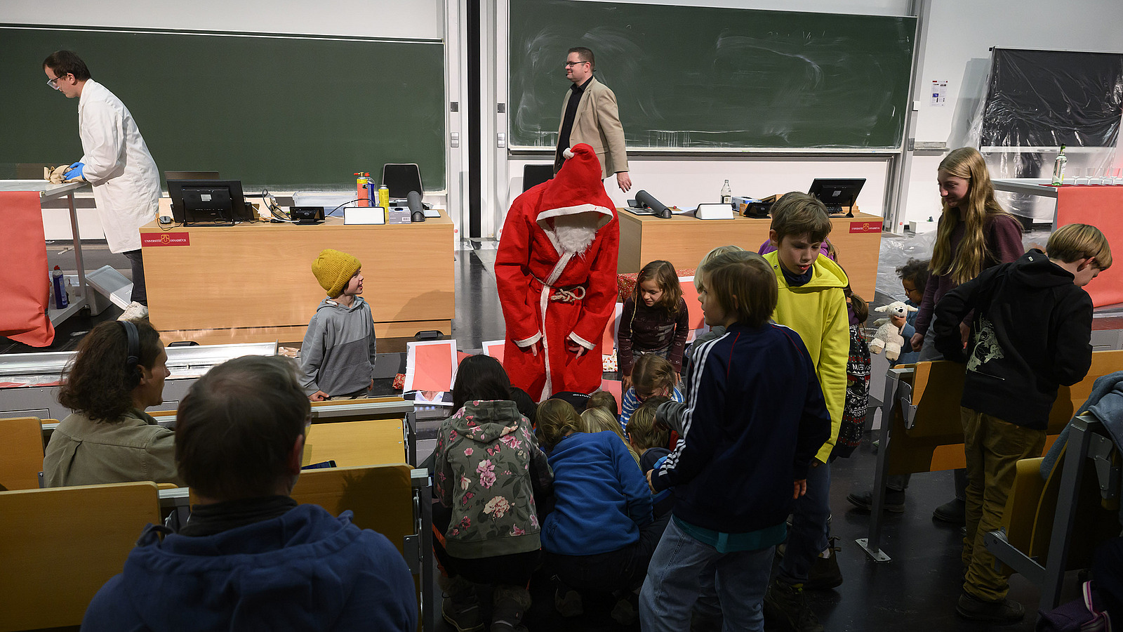 Personen unternehmen chemische Experimente vor Publikum