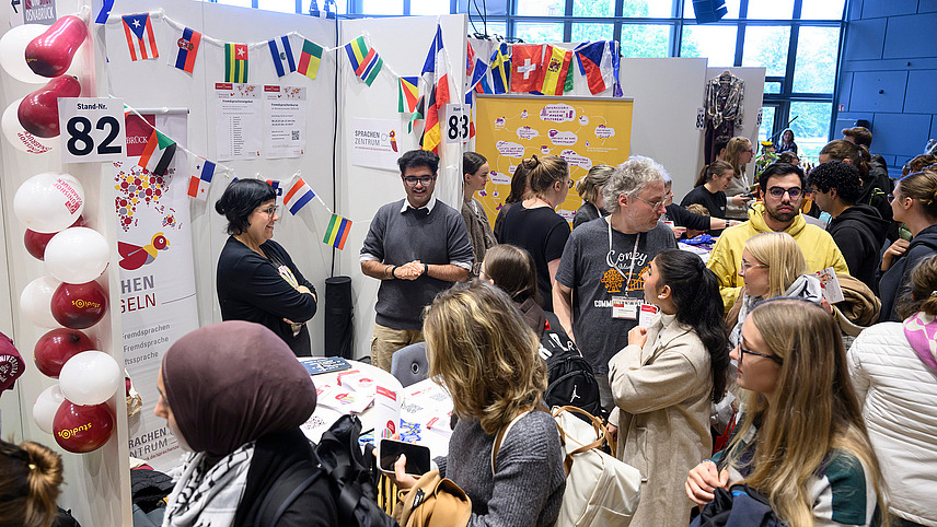 View of colorful booths with numerous people gathering information