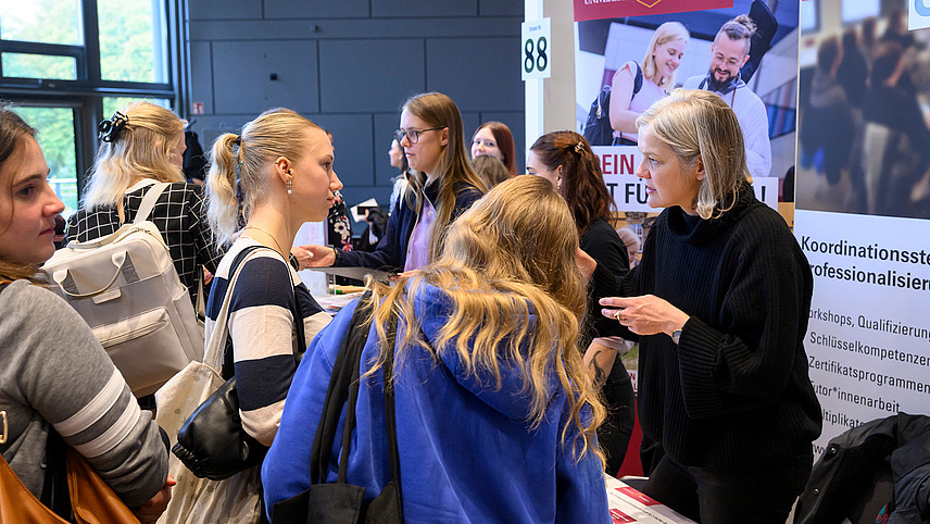Several people at an information booth