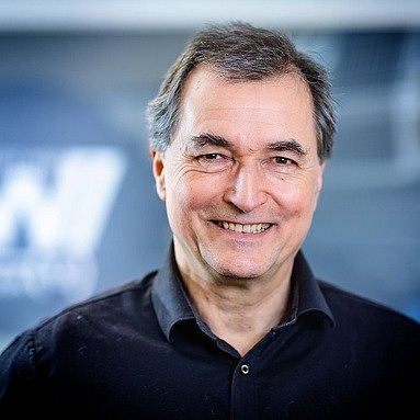 a man is smiling into the camera