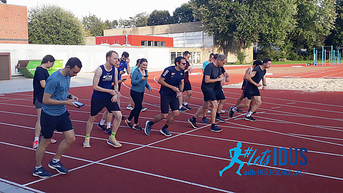 A group of runners at the starting line of a running track