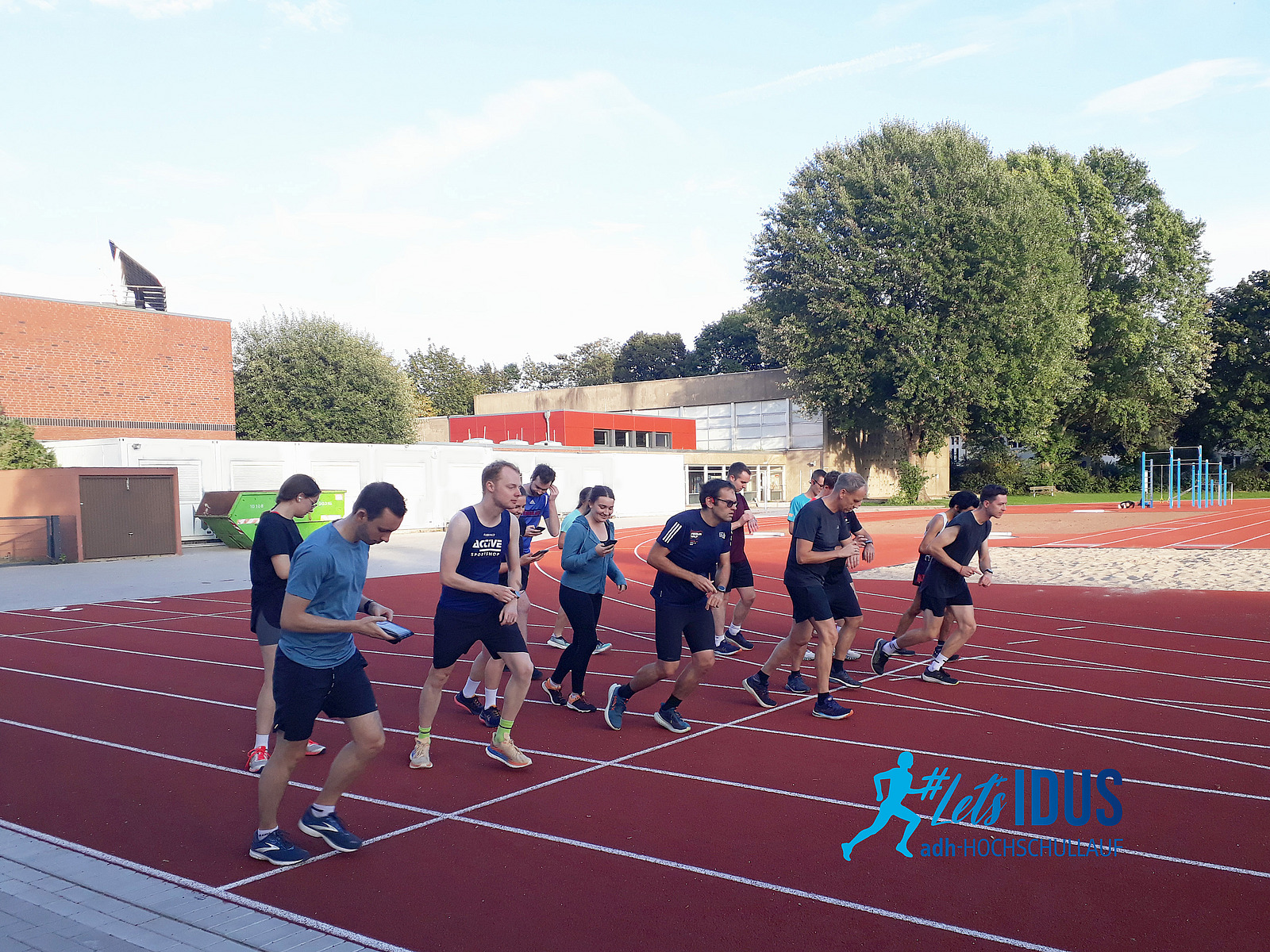 A group of runners at the starting line of a running track