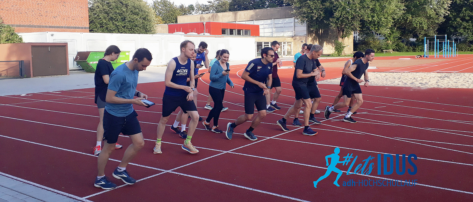 A group of runners at the starting line of a running track