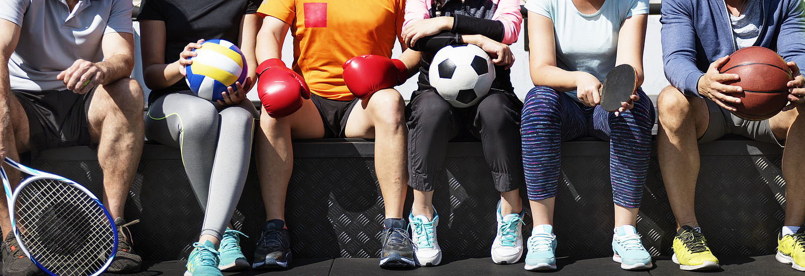 Gruppe verschiedener Sportler mit Sportgeräten