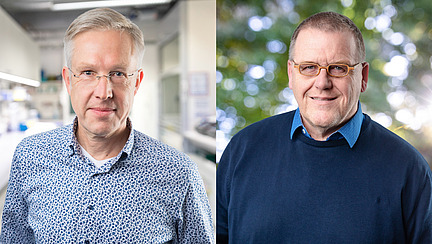 Zwei M&auml;nner l&auml;cheln in die Kamera.