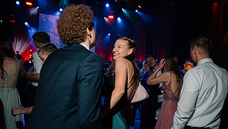 Festively dressed ball guests on a dance floor