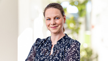A woman smiles at the camera