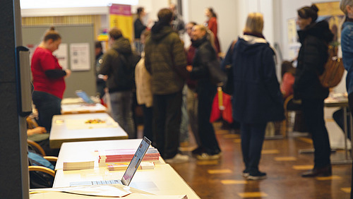 There are brochures and information material on tables. 