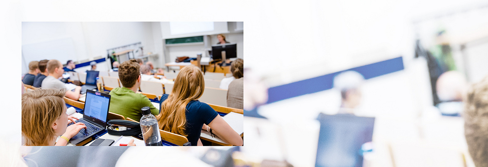 A lecture hall filled with students attentively following a lecture. 