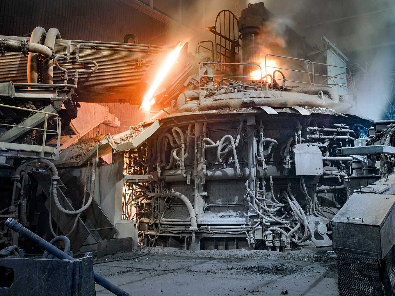 Innenansicht eines aktiven Stahlwerks mit einem großen Ofen in der Mitte