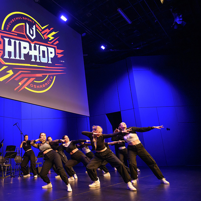 Several people dance hip hop on one stage