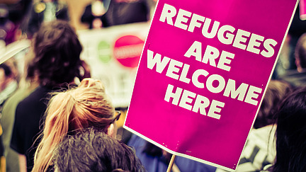 Protest sign "Regufees are welcome here"