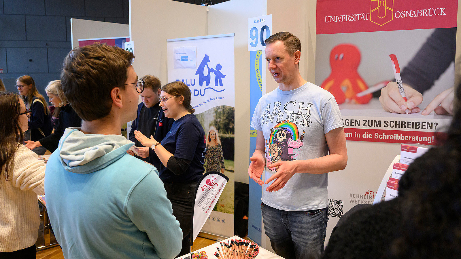 Several people at an information booth