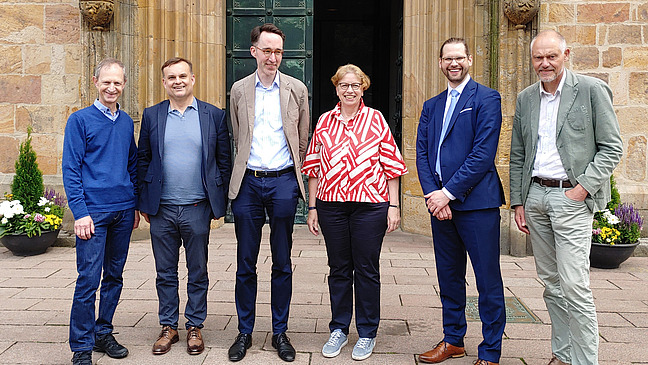 Mitglieder der AGKG vor dem Osnabr&uuml;cker Dom mit dem Leiter des Di&ouml;zesanmuseums, Dr. Hermann Queckenstedt