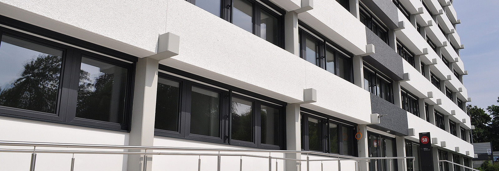 A modern multi-story office building is visible.
