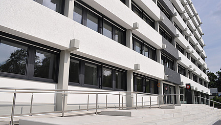 A modern multi-story office building is visible.