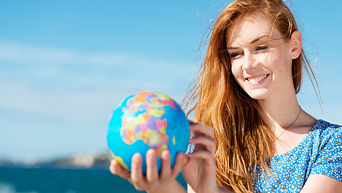 ERASMUS+ Woman holds a globe in her hands