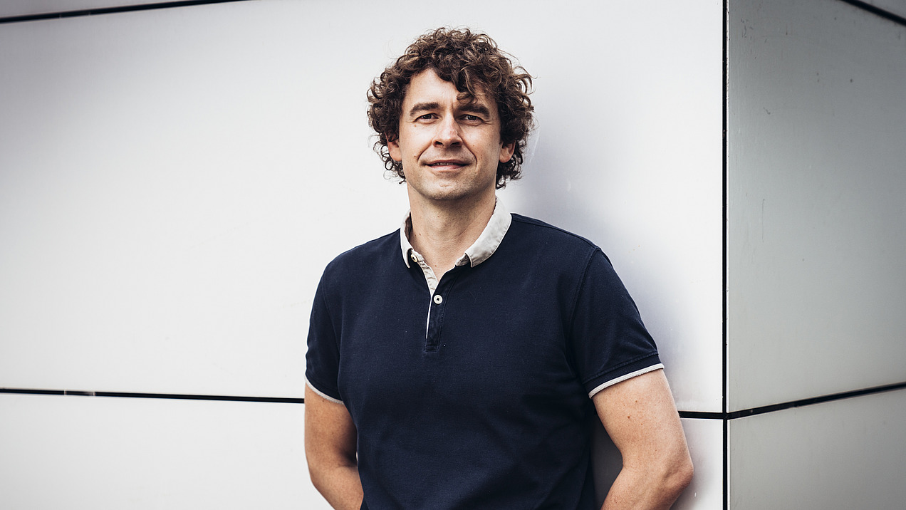 Portrait of a man with curly dark hair