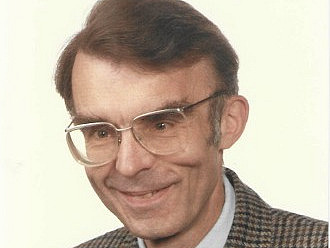 Portrait photo of a man with glasses. 