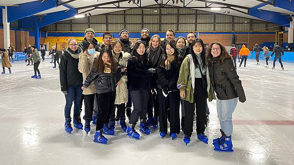 A group of international students stand in the middle of the ice rink in Osnabrück.