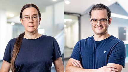 A woman and a man look at the camera