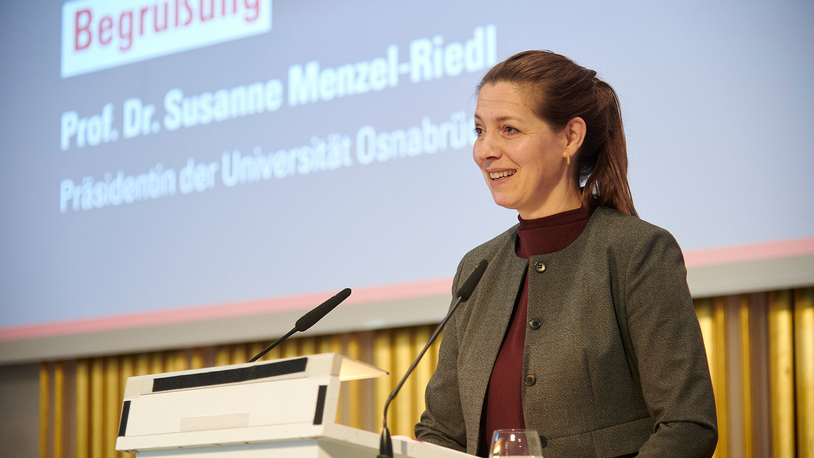 A person is standing at a lectern.