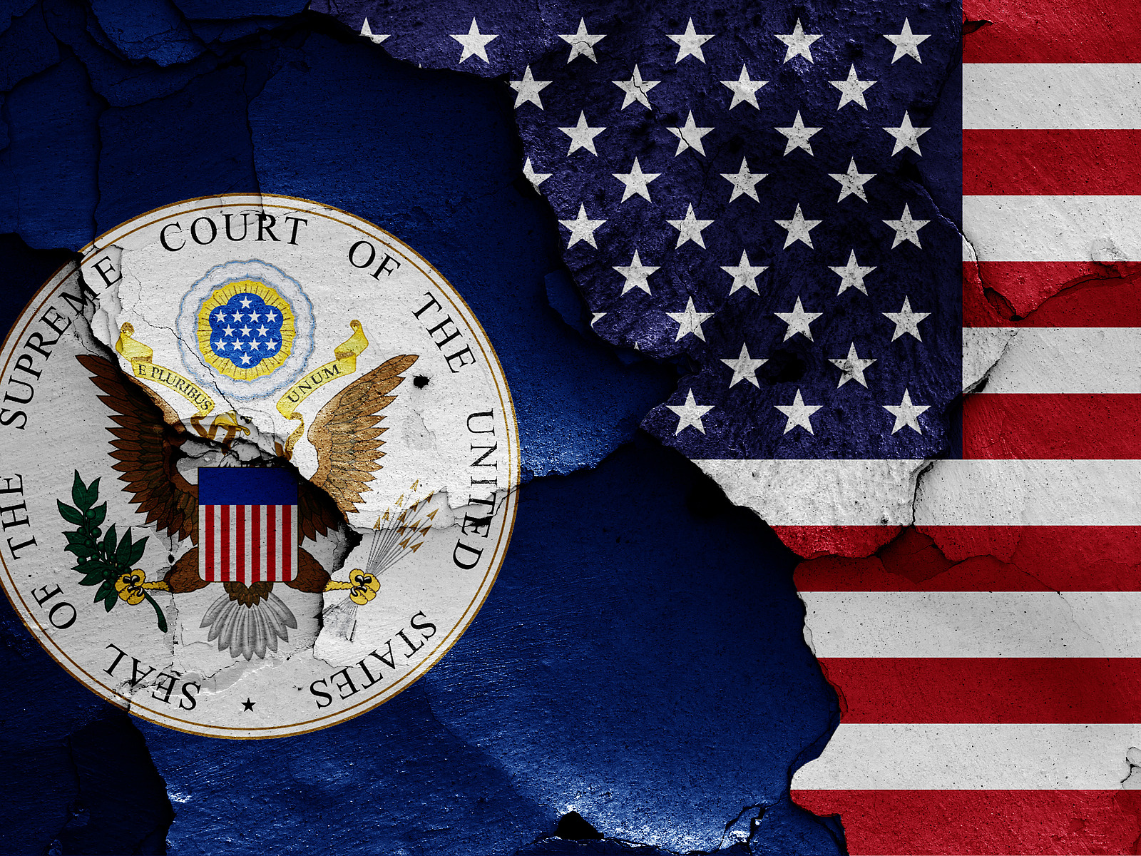 flags of Supreme Court of the United States and USA painted on cracked wall