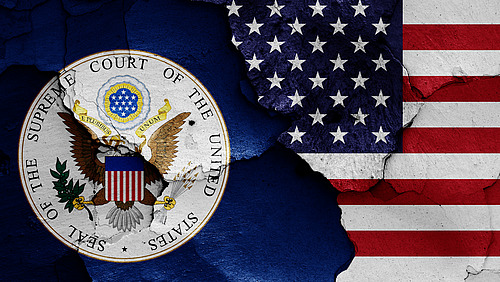 flags of Supreme Court of the United States and USA painted on cracked wall