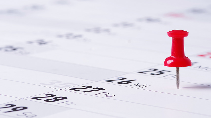 Pinnadel steckt auf Datum eines Terminkalenders