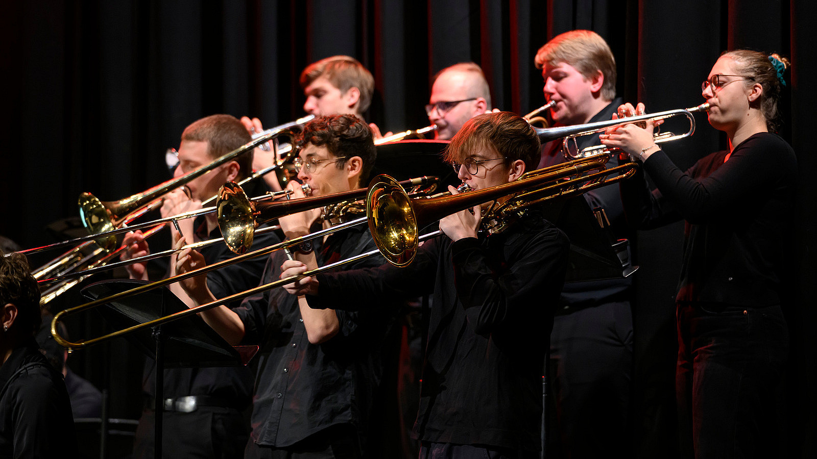 Close-up of several musicians with wind instruments
