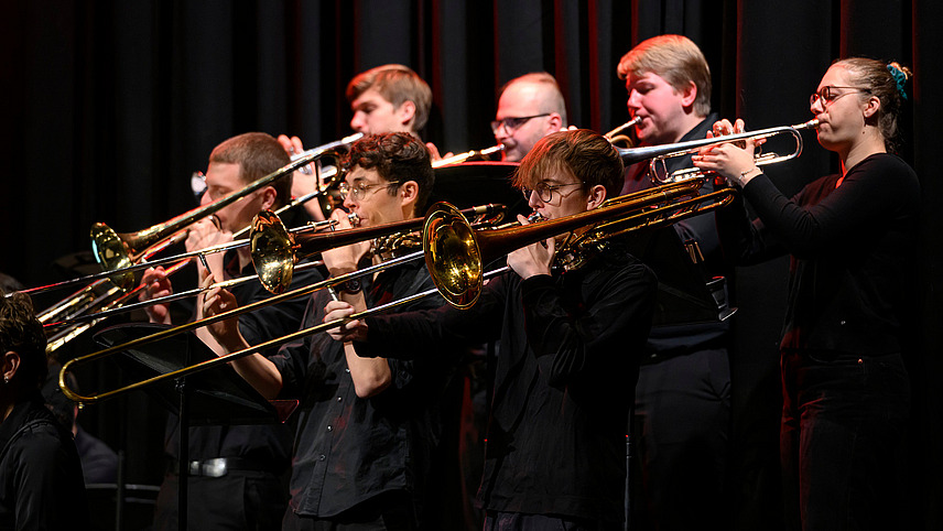Close-up of several musicians with wind instruments