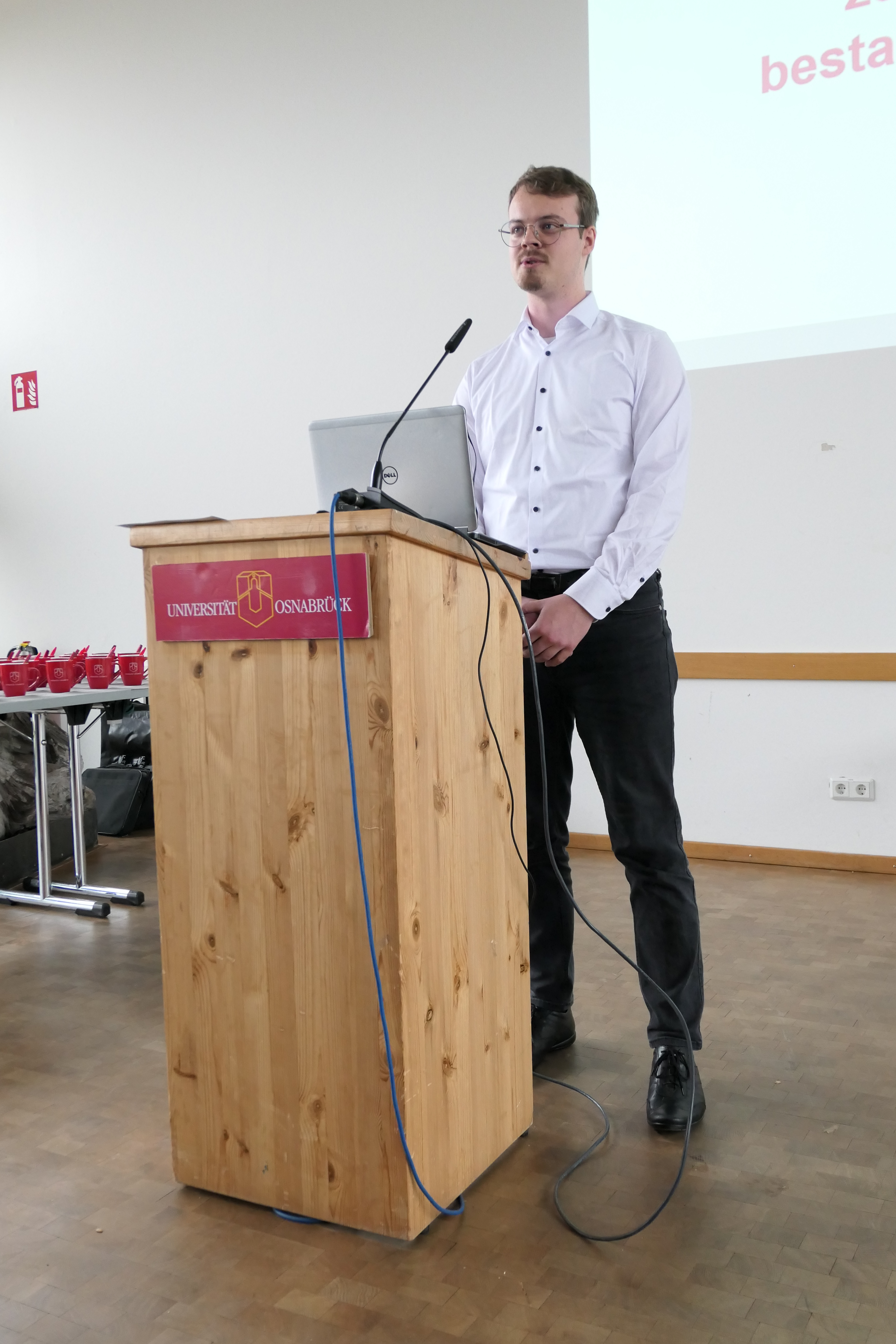 A student stands behind a lectern.