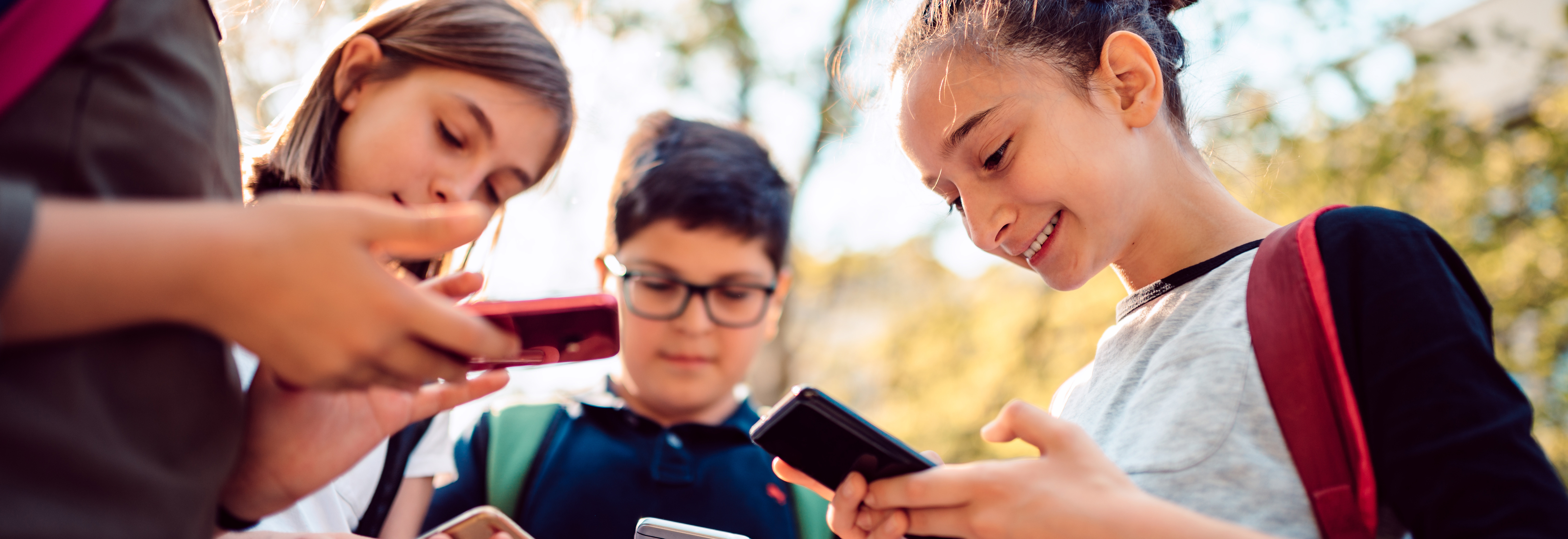 Kids playing video games on smart phone after school