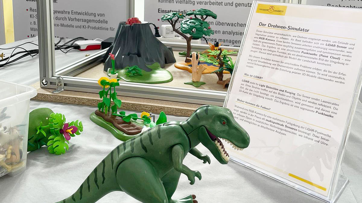 Close-up of a research poster on the topic of drone simulation. A toy dinosaur stands in the foreground.